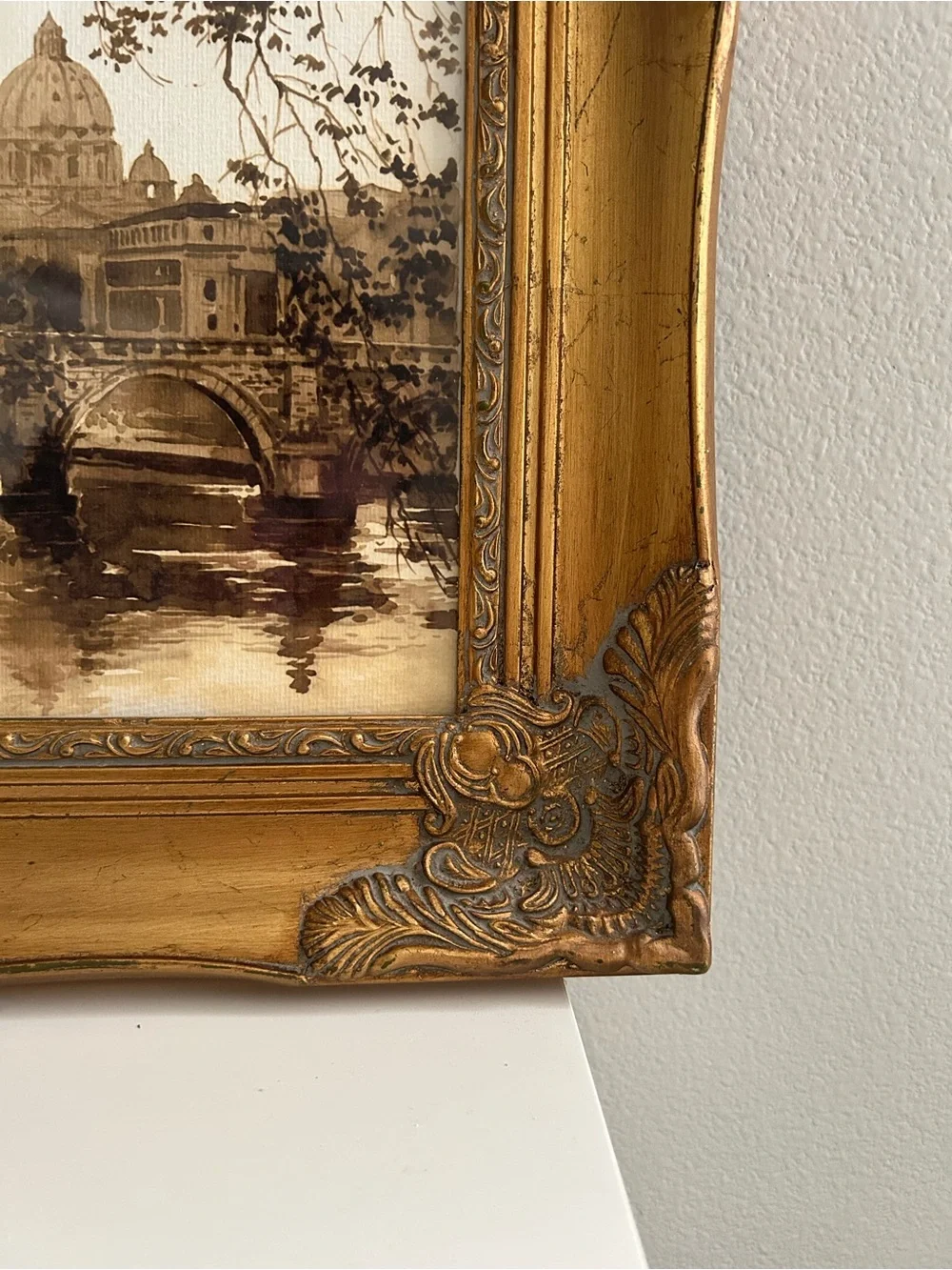 Framed art in gilded ornate frame